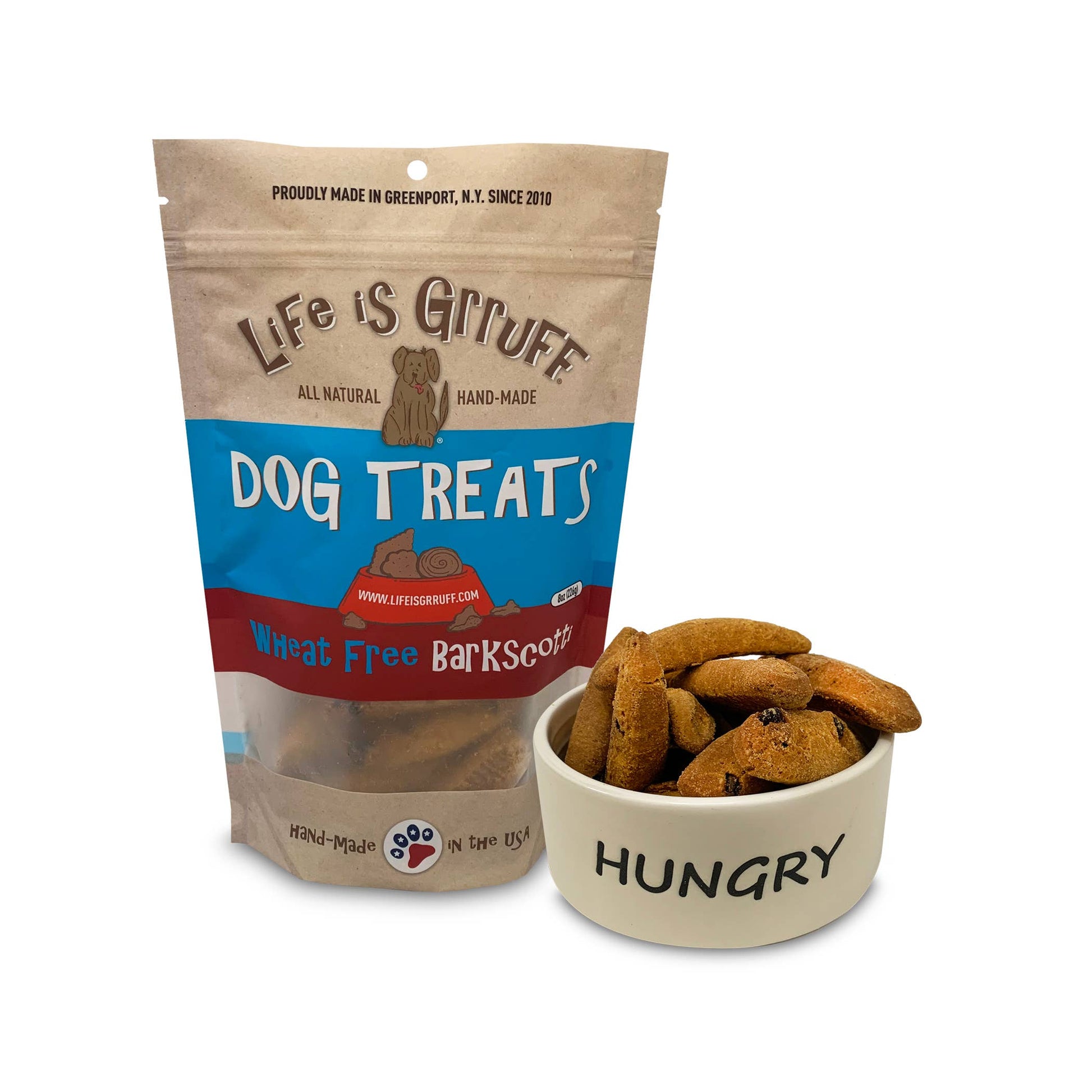 Close up of Wheat Free Barkscotti dog treat bag next to a bowl that says "HUNGRY" filled with treats