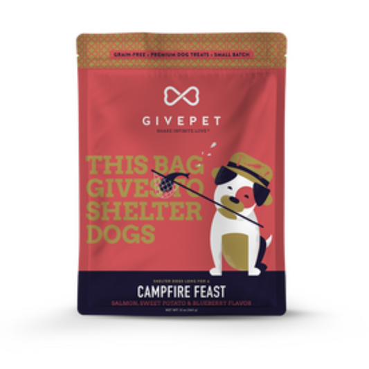 front view of Campfire Feast bag. Photo of dog wearing a fishing hat holding a stick with a fish in the net. Text on bag says "This bag gives to shelter dogs"