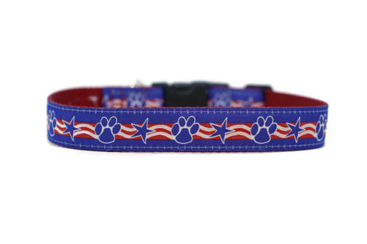 close up of collar. blue background with white outlined paws and stars and red and white stripes